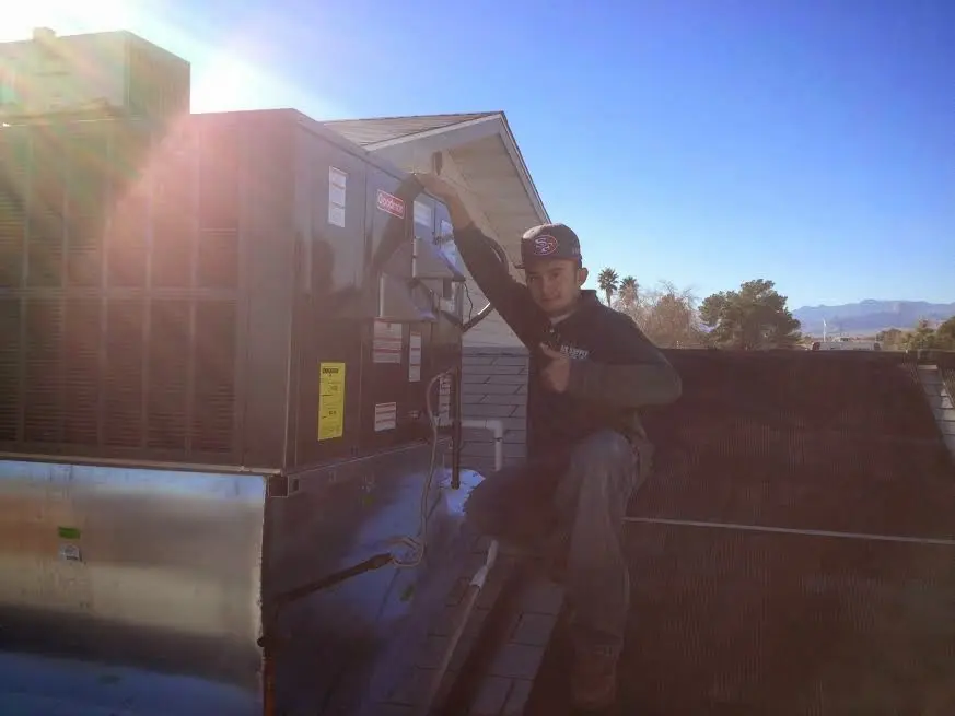 HVAC technician performing HVAC Inspection on a rooftop unit in Morgan Hill